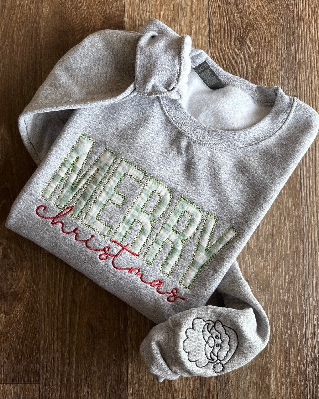 Embroidered Appliqué Merry Christmas Sweatshirt Santa Claus head details on the sleeves